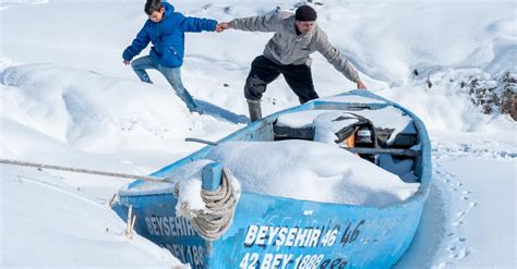 Father and Son Pulling their Boat on a Frozen Lake · Free Stock Photo