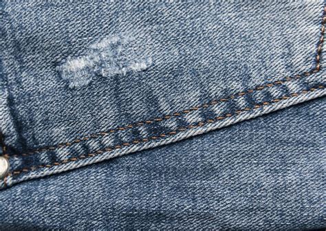 Premium Photo Denim Blue Jeans Texture With Scuffs And Holes