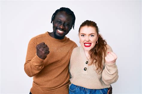 Interracial Couple Wearing Casual Clothes Very Happy And Excited Doing