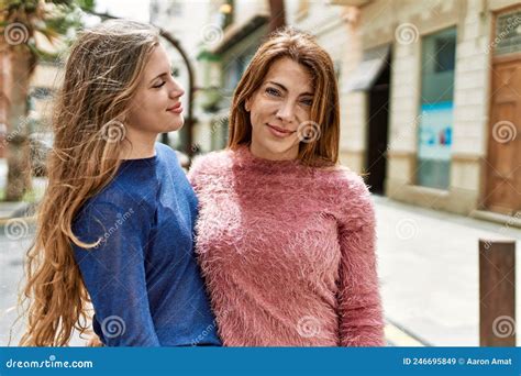 Mother And Daughter Smiling Confident Hugging Each Other At Street