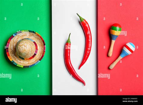 Mexican Sombrero Maracas And Hot Chili Peppers On Mexican Flag Background Stock Photo Alamy
