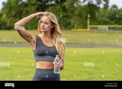 A Stunning Blonde Fitness Model Preps For A Workout Radiating
