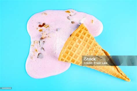 Top View Melted Sweet Potato Flavor Ice Cream Cone On A Blue Background