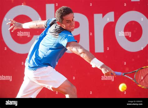 Spanish Tennis Player Nicolas Almagro Is Stretching To Hit A Backhand Shot During Atp Buenos