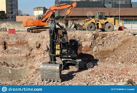 Two Excavators And A Bulldozer During A Redevelopment Of An Urban Area