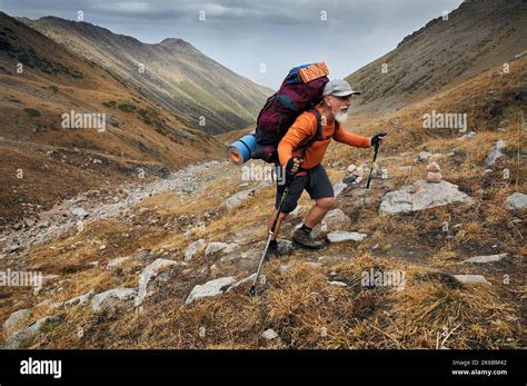 Portrait Of Old Bearded Man Hiker Tourist With Big Backpack And