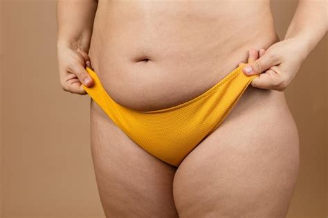 Premium Photo Cropped Image Of Overweight Woman Tucking Hiding Fat