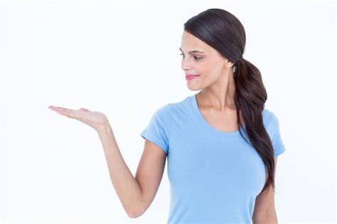 Premium Photo Pretty Brunette Presenting With Her Hand