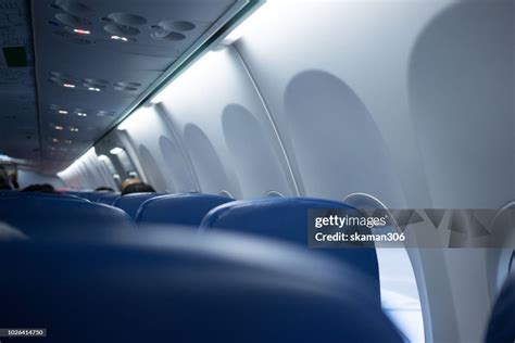 Boarding Passenger In Airplane High-Res Stock Photo - Getty Images