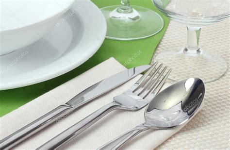 Table Setting With Fork Knife Spoon Plates And Napkin Stock Photo