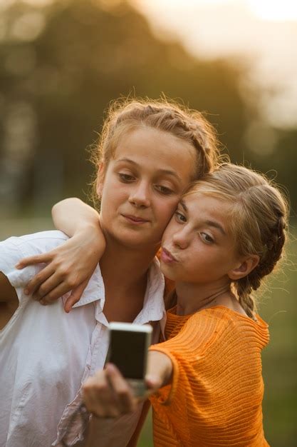 Premium Photo Friends Taking A Self Portrait Outdoor Two Girls Makes