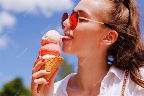 Premium Photo Girl Licks Ice Cream In A Cone Closeup In Hot Summer