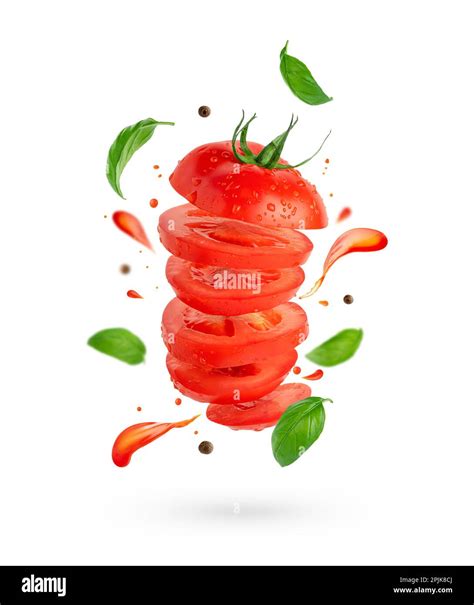 Flying Sliced Tomato With Flowing Splashes And Basil Leaves On White