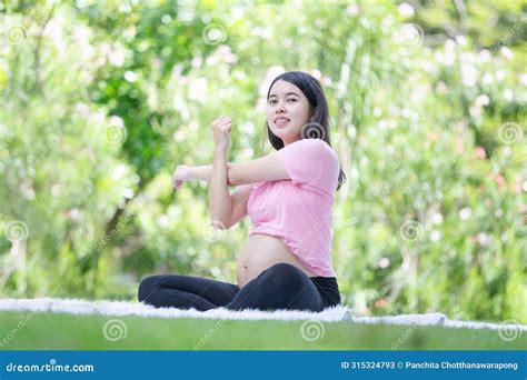 Asian Pregnant Woman Meditating While Sitting In The Park Woman Doing