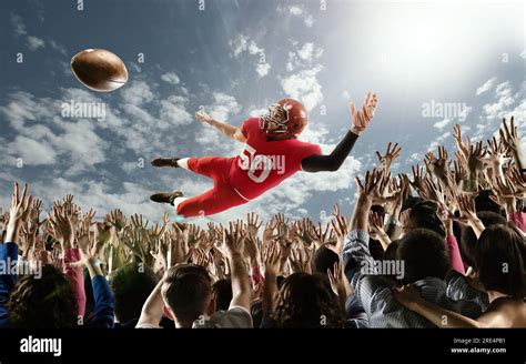 Professional American Football Player Flies Over Hands Of Fans And