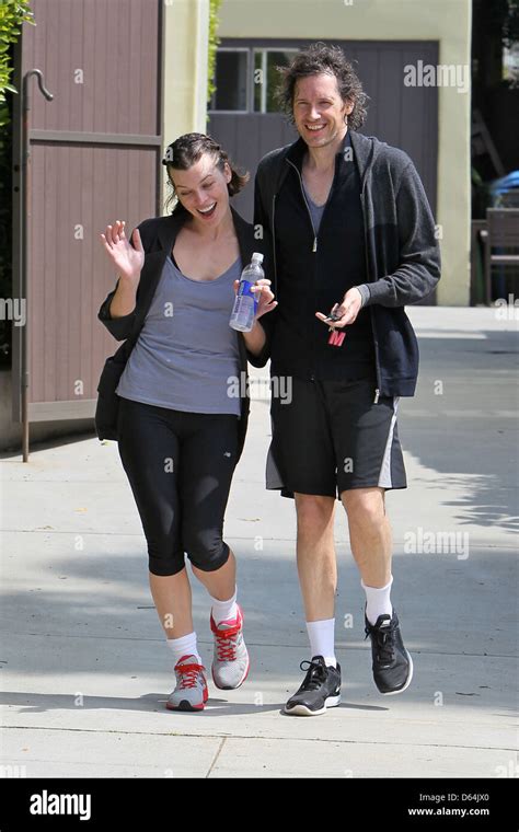 Milla Jovovich and her husband seem in good spirits as they leave their ...