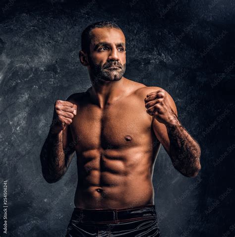 Professional Muay Thai Boxer With Naked Torso Posing For A Camera