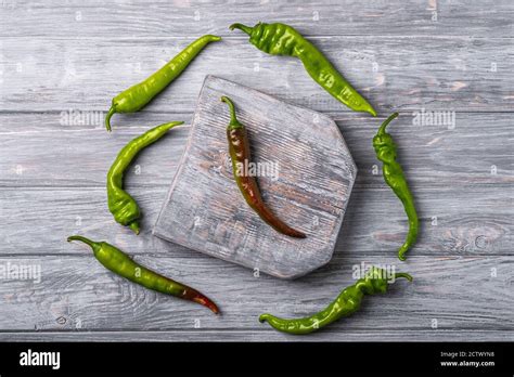 Hot Spicy Green Chili Peppers On Wooden Cutting Board Wood Backdrop Background Top View Stock