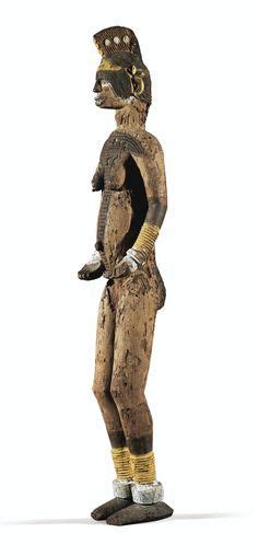 A Wooden Statue Of A Man Wearing A Helmet And Boots