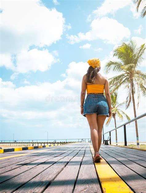 Sun Kissed Serenity Joyful Latina Woman Strolling On Sunny Beach Pier