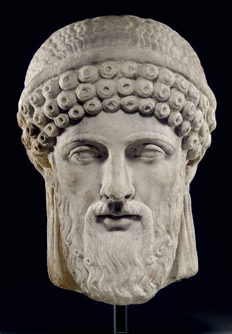 A Roman Marble Archaistic Head Of Dionysos Circa 2nd Century Ad