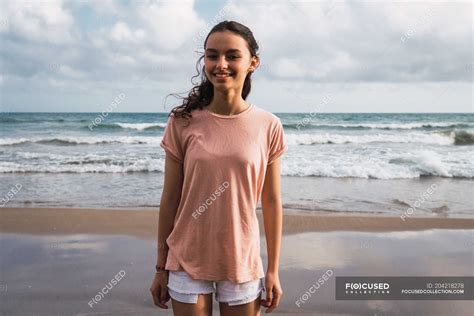 Portrait Of Smiling Teen Girl Standing On Beach — Seashore Childhood