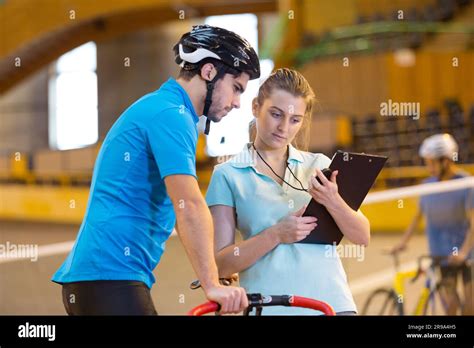 male cyclist with coach training in the velodrome Stock Photo - Alamy