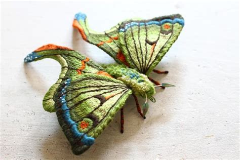 Two Green And Blue Butterflies Sitting On Top Of A White Countertop