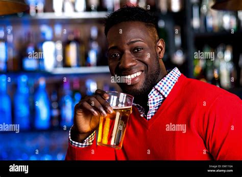 Guy Drinking Beer In A Nightclub Stock Photo Alamy
