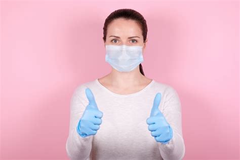 Premium Photo Portrait Of A Brunette Girl In A Medical Mask And Blue