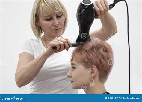 Woman Hairdresser Makes Hairstyle In A Beauty Salon Stock Image Image