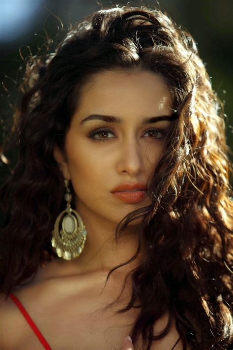 Download Woman With Curly Hair Large Earrings Wallpaper