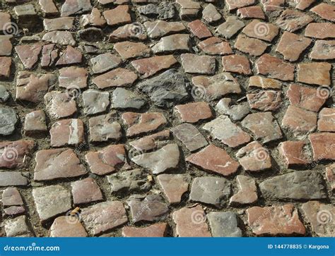 An Old Stoneblock Pavement Cobbled With Natural Stone Blocks With Gaps