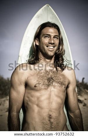 Attractive Handsome Muscular Long Haired Surfer Posing With His