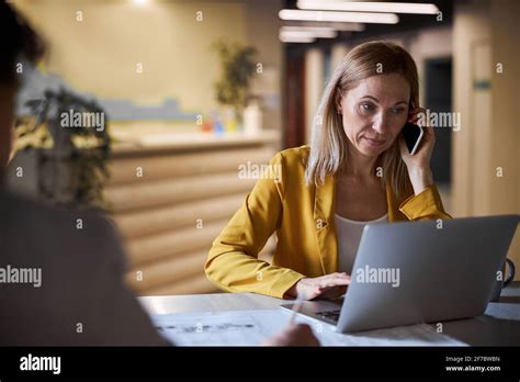 Busy Blonde Female Looking At Screen Of Her Laptop Stock Photo Alamy