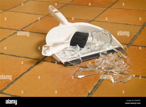 Remnants Pile Of Broken Glass On Floor After Accident And Glass Slipped Out Of Wet Hands Knocked