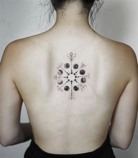 Vegvísir and moon phases tattoo on the upper back