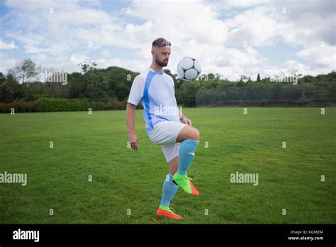 Football Player Juggling Soccer Ball In The Ground Stock Photo Alamy