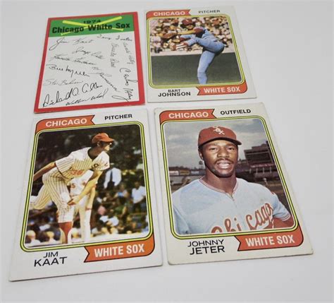 Four Baseball Cards With Autographs On Them Sitting On A Table In Front