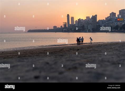 India, Maharashtra, Mumbai, People on Chowpatty Beach, Sunset, Skyline ...