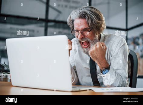Expressive Mature Businessman With Grey Hair And Beard In Formal