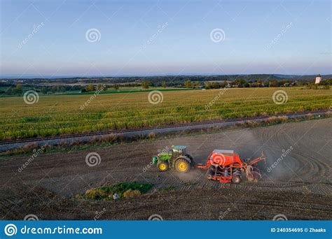 A Green Tractor Plows The Ground Near The Railway Top View Soil