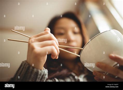 Brunette Eating With Chopsticks Stock Photo Alamy