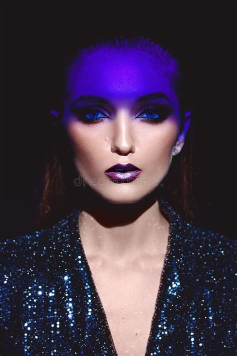 Portrait Of Fashion Girl With Stylish Makeup And Blue Neon Light On Her