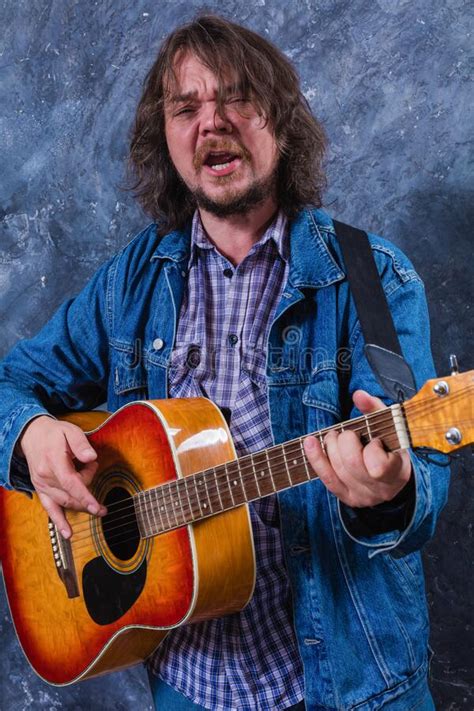 Mature Musician Plays Acoustic Guitar Studio Portrait Stock Image