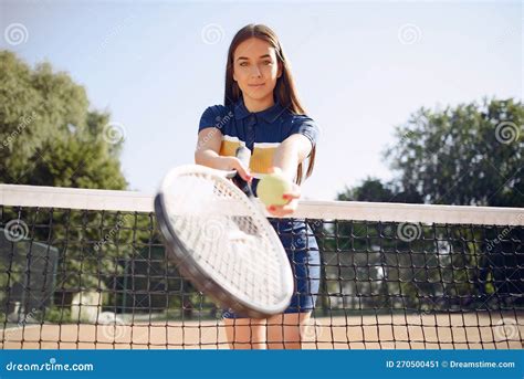 Caucasian Female Tennis Player Holding A Racket And Posing For A Photo