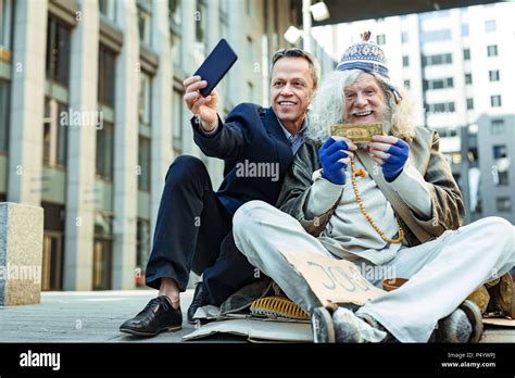 Charity man encouraging other people helping homeless Stock Photo - Alamy