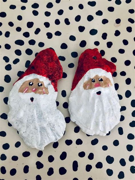 Two Red And White Santa Claus Slippers Sitting On Top Of A Polka Dot