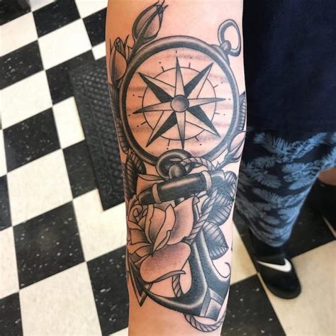 A Man S Arm With An Anchor Compass And Rose Tattoo Design On It