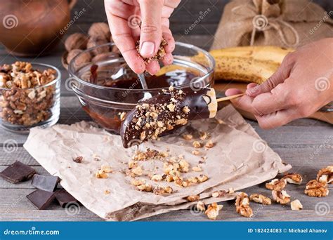 Woman Hands Sprinkle Nuts On A Frozen Banana Frozen Chocolate Bananas